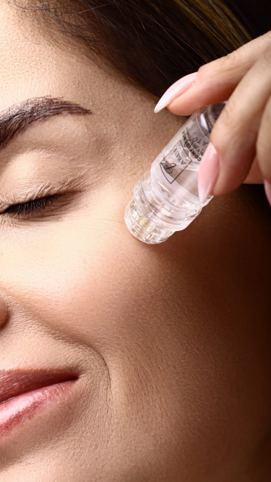 FABULI Hydra Needle applying serum to cheek — real result